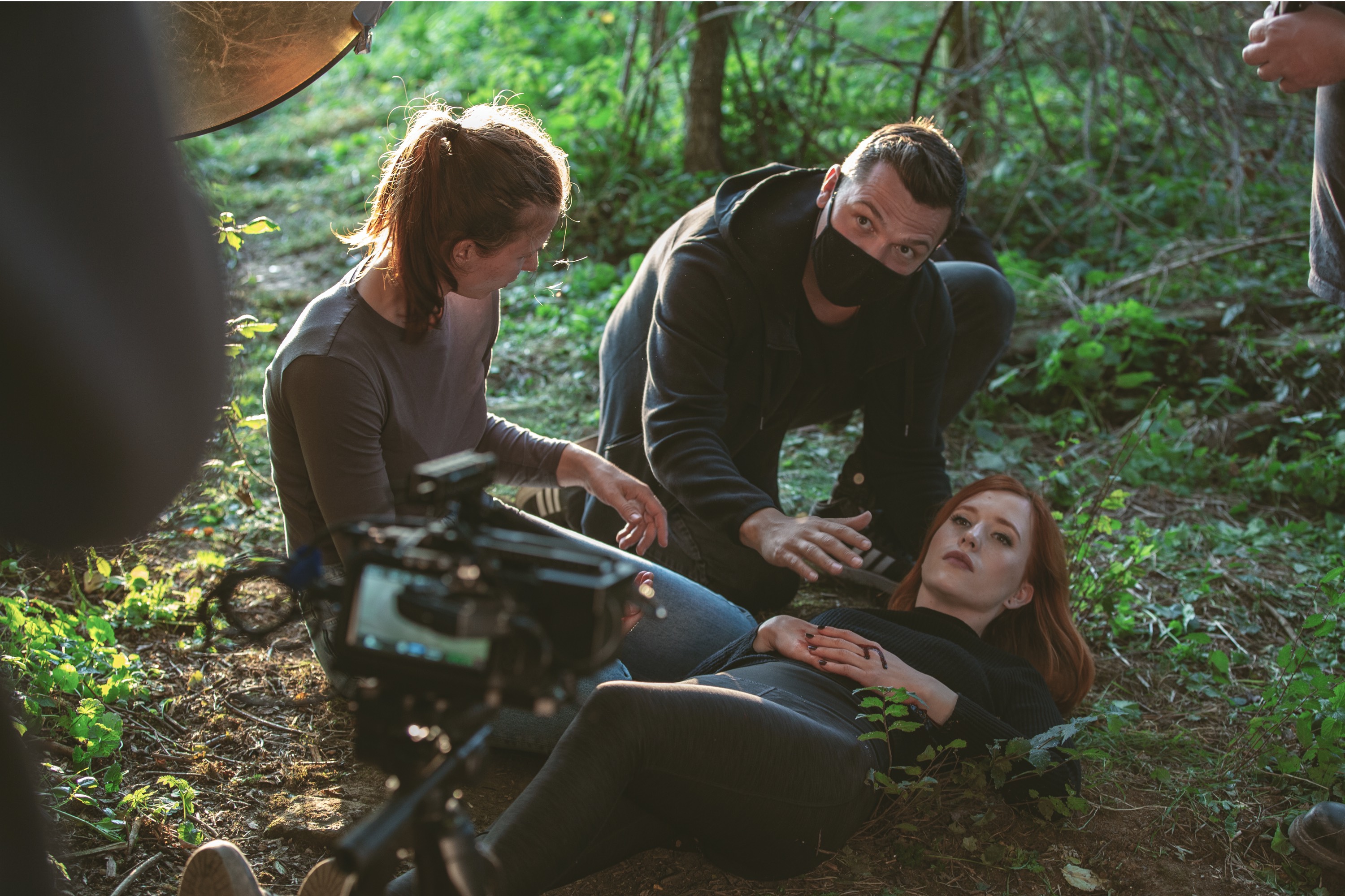 DJ facing a crowd at his deck. Photo with a purple hue